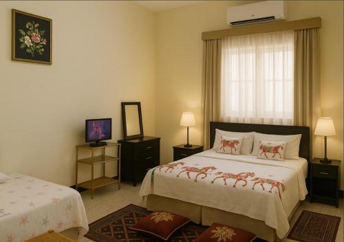 a hotel room with two beds and a window at Chez Naceur in Tozeur