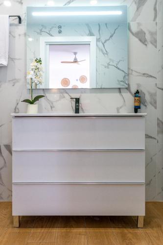 a bathroom with a sink and a mirror at Apartamentos Cibeles Centro Histórico in Mérida