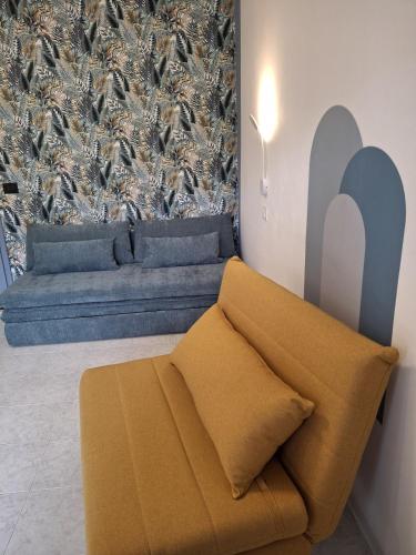 a couch in a room with a wall with birds at Artistika on the beach in Bibione