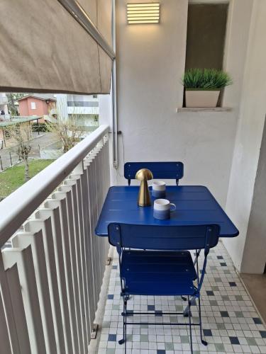 a blue table and chairs on a balcony at Artistika on the beach in Bibione