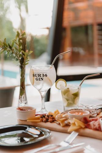 a table with a plate of food and a wine glass at Puerto Dijama Hotel Boutique in Carmelo