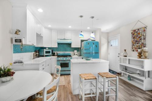 a kitchen with white cabinets and blue appliances at 359SA 359 Sumner A in Avalon