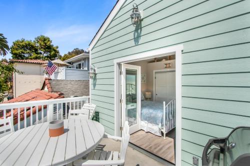 a green house with a porch and a deck at 359SA 359 Sumner A in Avalon