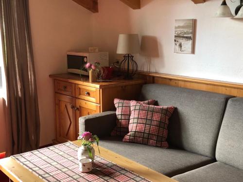 a living room with a couch and a table at Gästehaus Tanneck in Reit im Winkl
