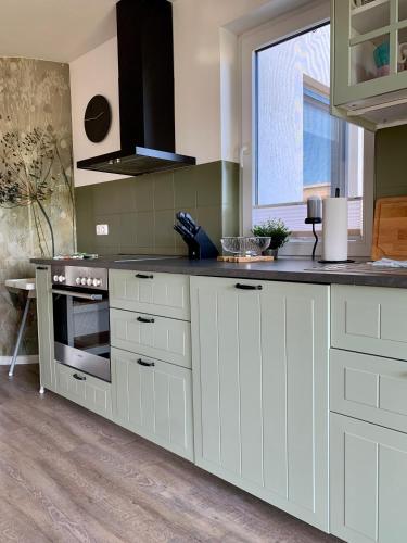 a kitchen with white cabinets and a counter top at Direkt am Meer in Fehmarn