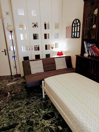 a living room with a bed and a couch at CHRYSSA - ΧΡΥΣΑ in Patra
