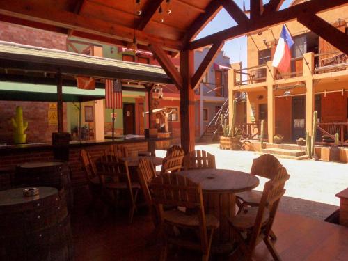 a patio with wooden tables and chairs in a restaurant at West Refugio in San Juan del Río