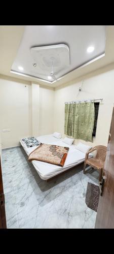 a bedroom with a large bed in a room at hotel shree shivganga in Ujjain