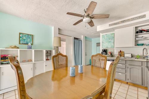 a kitchen with a table and chairs and a ceiling fan at Withlacoochee River Rental with Dock Access! in Yankeetown