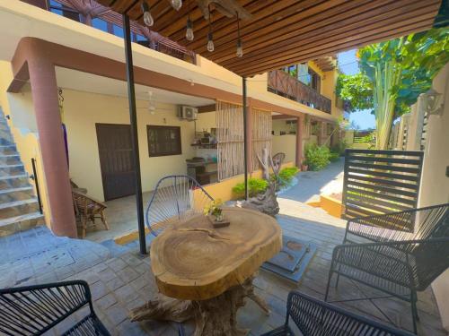 a patio with a wooden table and chairs on a patio at Casa Majagua in Brisas de Zicatela