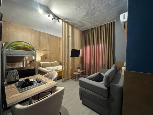 a living room with a couch and a table at VILLA CABARE Apartments&Rooms in Durrës