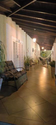 a living room with a couch in the middle of a room at Spa Belo Quinto Prime in Brotas