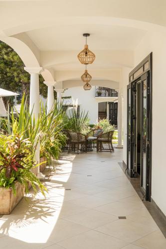 an open porch with plants and a chandelier at Casa Bonita Hotel & Luxury Residence in Oaxaca City
