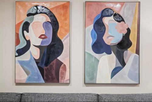 two paintings of a woman on a wall at Modern and Cozy 3BD Home in Gibsonia-Pittsburgh in Bakerstown