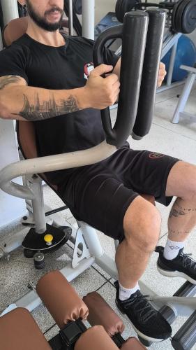 a man sitting on a chair in a gym at Spa Belo Quinto Prime in Brotas