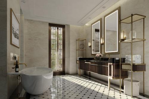 a bathroom with a large tub and a large mirror at InterContinental Halong Bay Resort by IHG in Ha Long