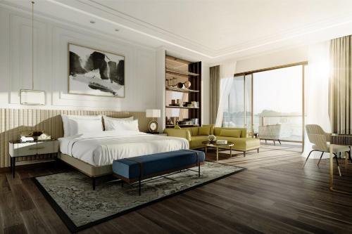 a bedroom with a bed and a living room at InterContinental Halong Bay Resort by IHG in Ha Long