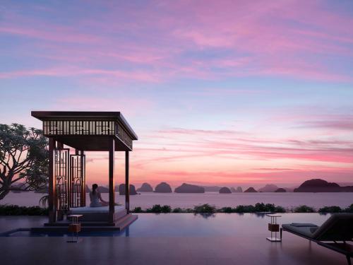 a person sitting in a gazebo overlooking the water at InterContinental Halong Bay Resort by IHG in Ha Long