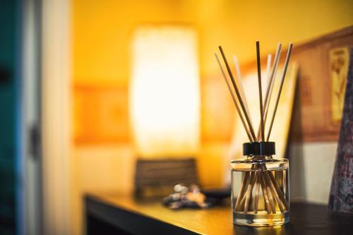 a glass vase with sticks in it on a table at InterContinental Halong Bay Resort by IHG in Ha Long