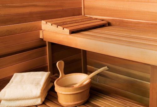 a sauna with a bucket and a wooden spoon at InterContinental Halong Bay Resort by IHG in Ha Long