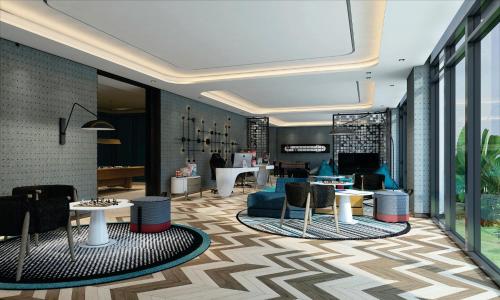 a lobby with tables and chairs in a building at InterContinental Halong Bay Resort by IHG in Ha Long