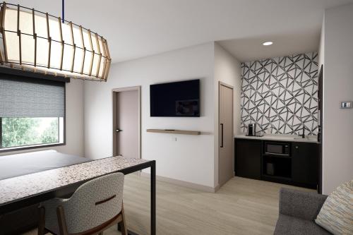a kitchen and dining room with a table and chairs at Atwell Suites Belgrade - Bozeman Airport by IHG in Belgrade