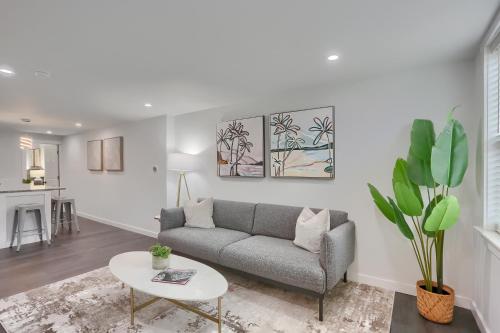 a living room with a couch and a table at Stylish and Central 3BD Home Pittsburgh North Side in Pittsburgh