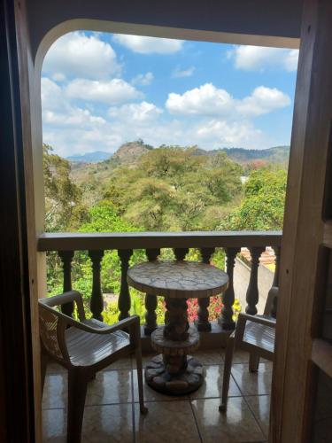 a view from a balcony with a table and chairs at Hotel La Escalinata in Copan Ruinas
