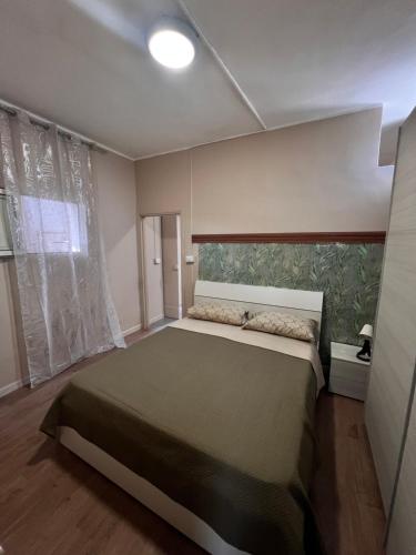 a bedroom with a large bed in a room at Appartamenti Minturnae Relais in Minturno