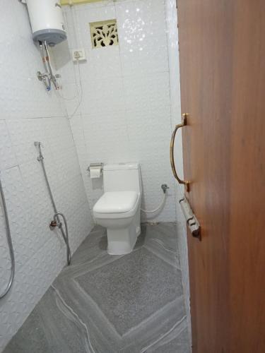 a bathroom with a white toilet in a room at Lemon Tree Homestay Darjeeling in Darjeeling