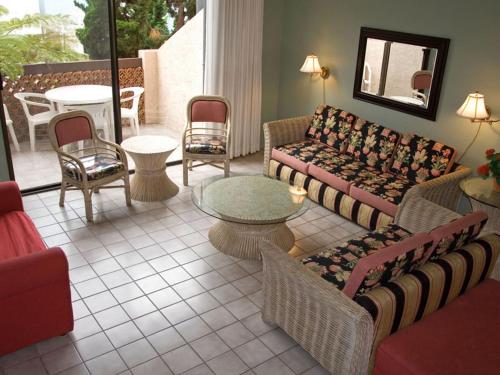 a living room with couches and a table and chairs at Bahia Vista A11 in Avalon