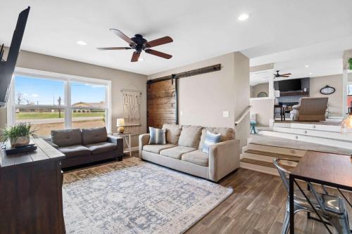 a living room with a couch and a ceiling fan at Rogers Family Retreat in Rogers