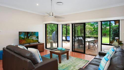 a living room with a couch and a table at Misty Creek of Robertson in Robertson