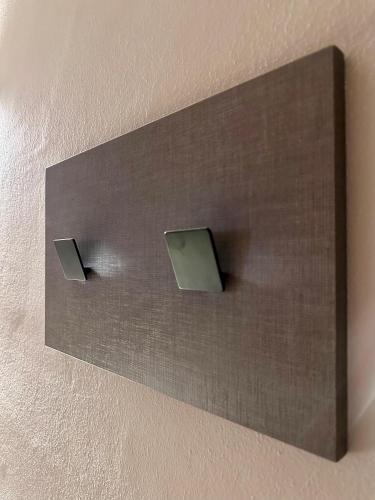 a wall with two boxes on the wall at Alloggi Centrale in Porto Tolle