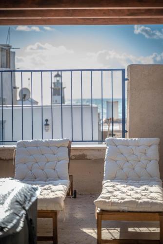 two chairs on a balcony with a view of the ocean at Nov Antique - AKKO in ‘Akko