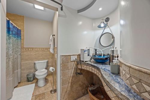 a bathroom with a toilet and a shower at Bahia Vista C53 in Avalon