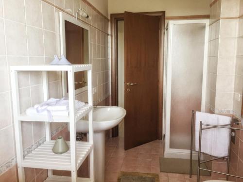 a white bathroom with a sink and a mirror at Appartamento Mare Nardo in Porto SantʼElpidio