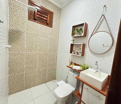 a bathroom with a shower and a toilet and a sink at Casa com Piscina Privativa na Lagoa do Paraíso - John House Paradise in Jijoca de Jericoacoara