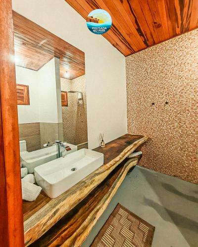 a bathroom with a white sink and a mirror at Pousada no Mar in Amontada
