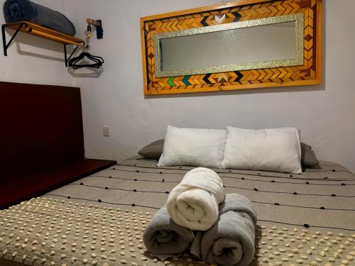 a bedroom with two beds with towels on the floor at Akoma San Pancho in San Francisco