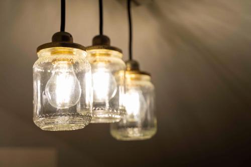 a group of four mason jars with lights in them at Appartamento incantevole in centro città in Alghero