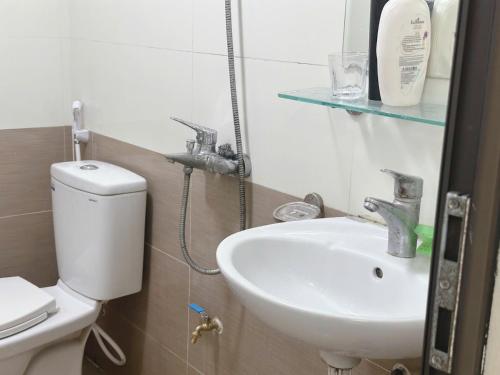 a bathroom with a sink and a toilet at Homely Hideout 501DT in Hanoi
