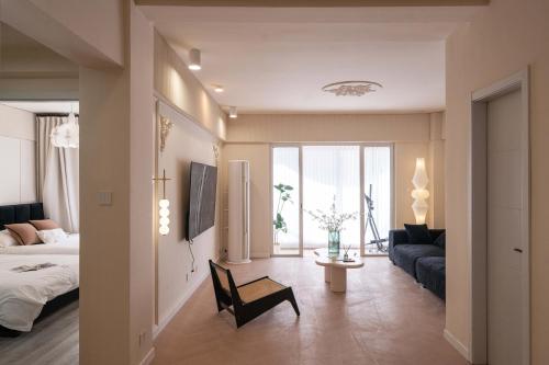 a living room with a bed and a couch at Molly Homestay - Nanjing East Road the Bund 3-Bedroom with Elevator Apartment in Shanghai