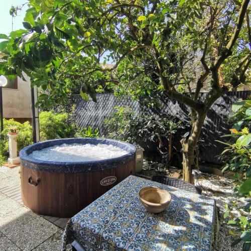 a bowl on a table next to a hot tub at La Rondine B&B in Massa Lubrense