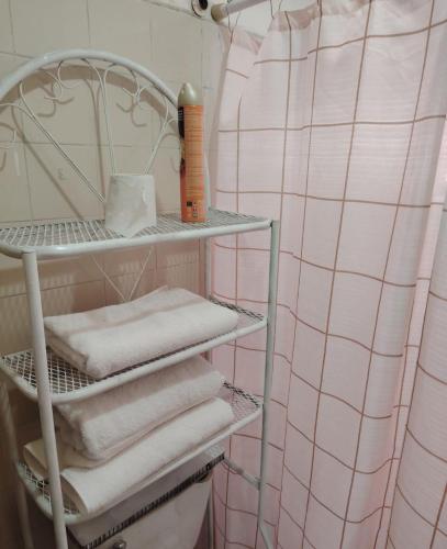 a towel rack with towels on it in a bathroom at Departamento 2 a 200 mts de Imss 25 in Monterrey