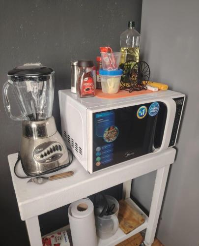 a microwave on a shelf with a blender on it at Departamento 2 a 200 mts de Imss 25 in Monterrey