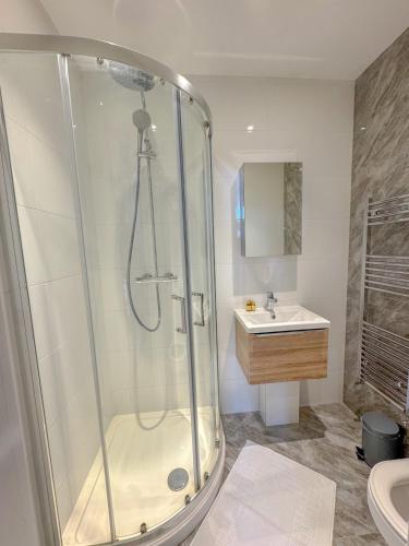 a bathroom with a shower and a sink at Earls Court Residences in London