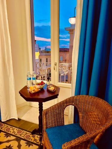 a table with food on it in a room with a window at Sedile Dei Nobili Apartment in Tropea