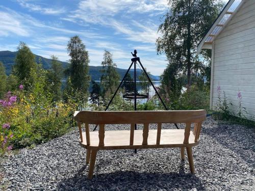 a bench with a swing in front of a house at Leiligheten in Fyresdal