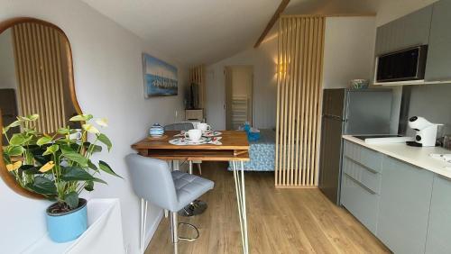 安德诺莱斯贝恩Le "Refuge du Marin" confort et calme pour 2 personnes的一间带桌子的小厨房和一间餐厅